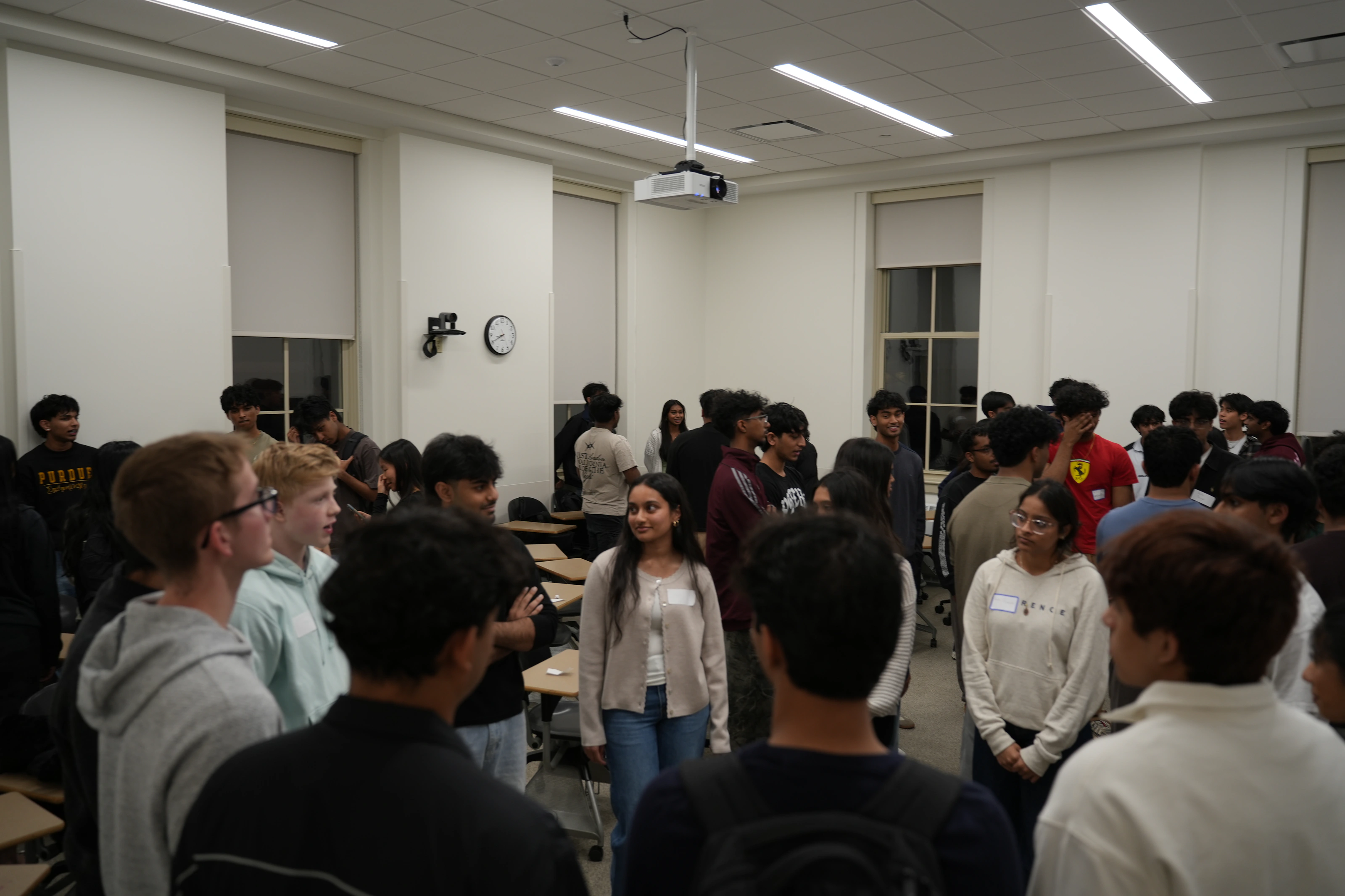 KTP members and prospective members talking together at a Purdue colony event