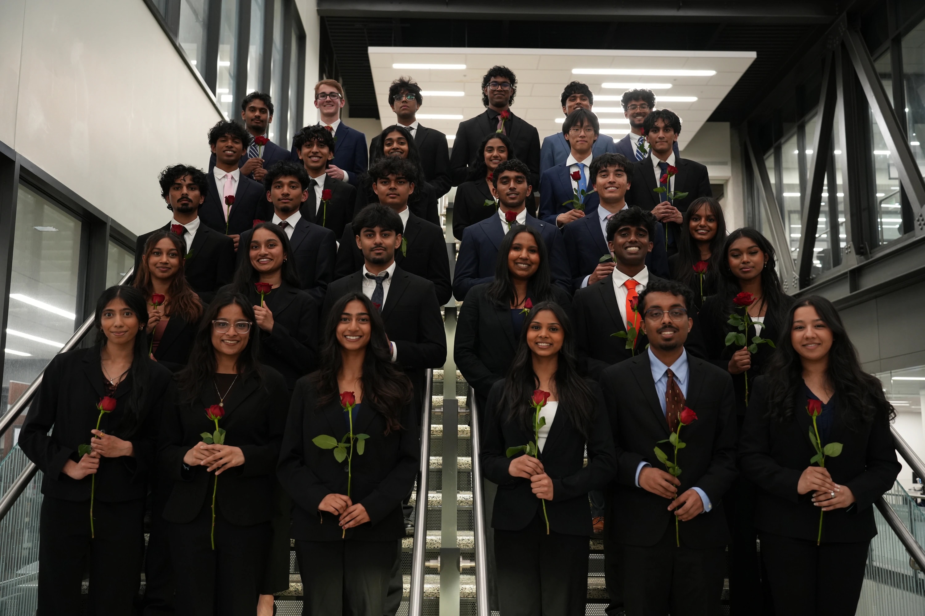 New KTP members holding roses together after initiation